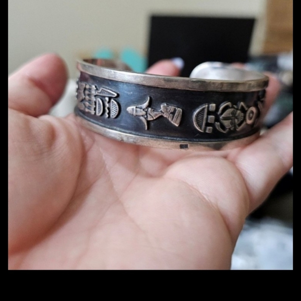 Sterling silver cuff. Looks like some type of storyteller. Maybe egyptian?. I do
